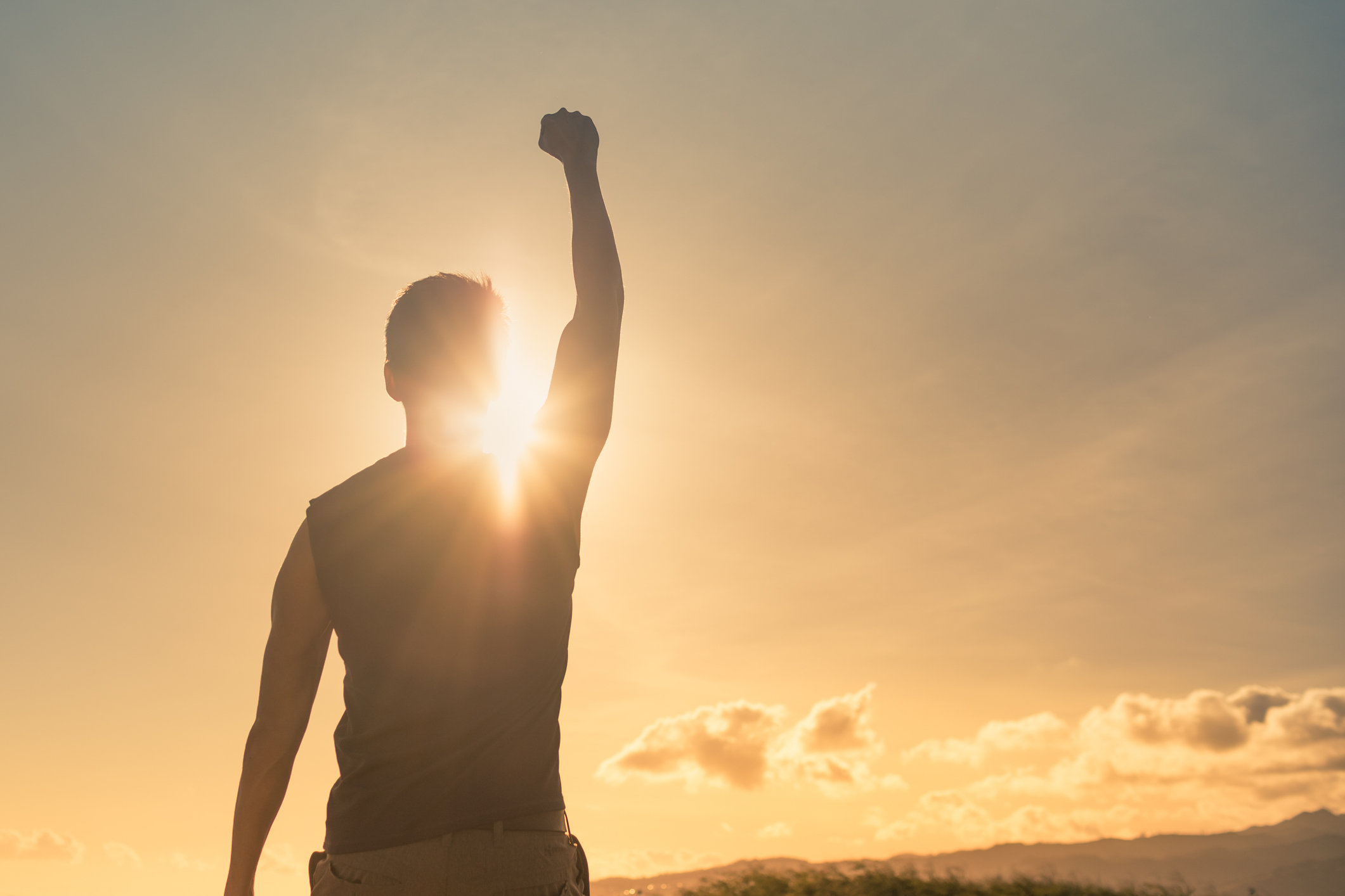 Man standing with victory fist in the air after hearing about these health tips