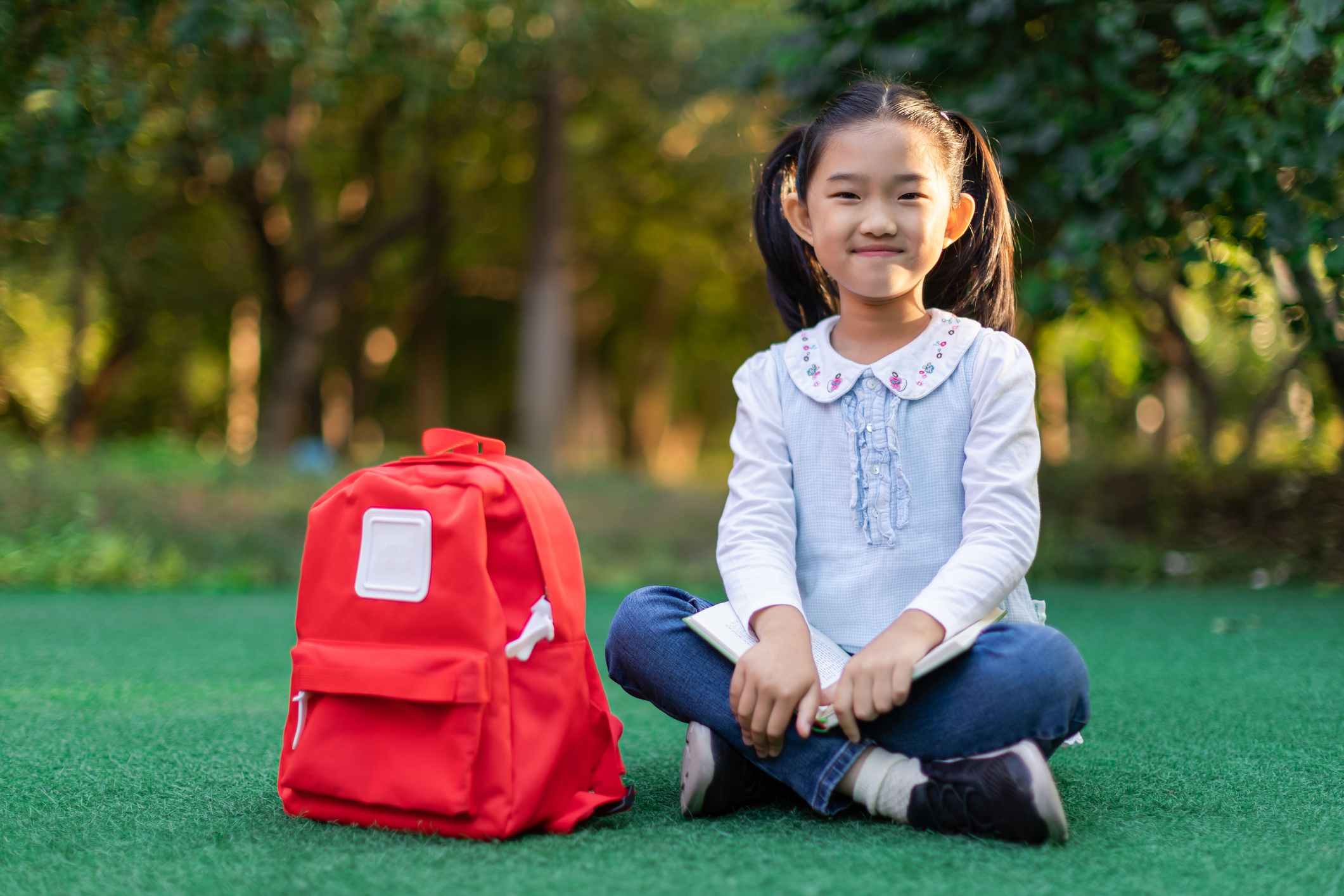 Little Girl Sitting with correct posture for back to school pictures